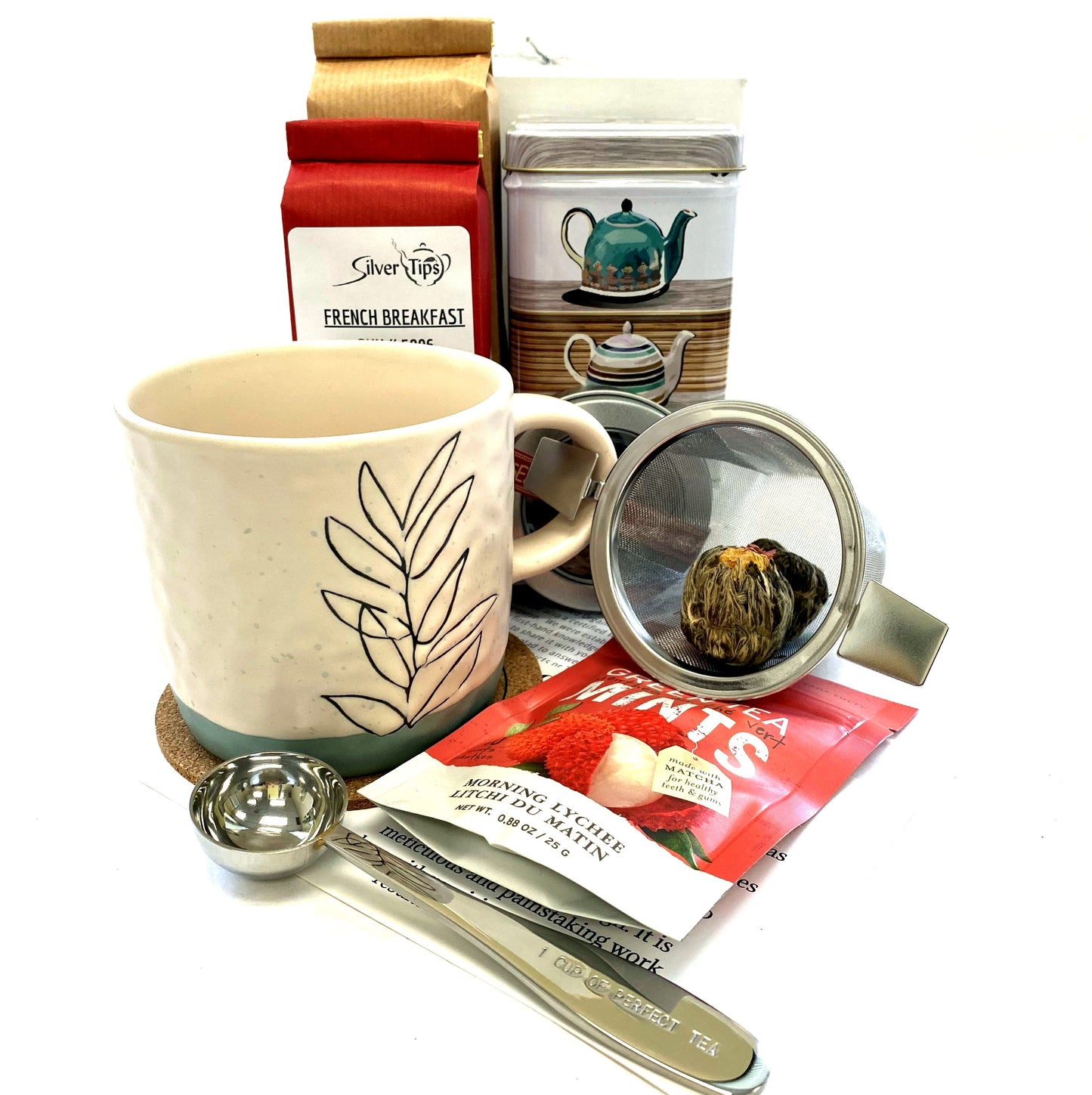 Gift box with a variety of teas, infuser, mesuring scoop, canister, tea mug and mints
