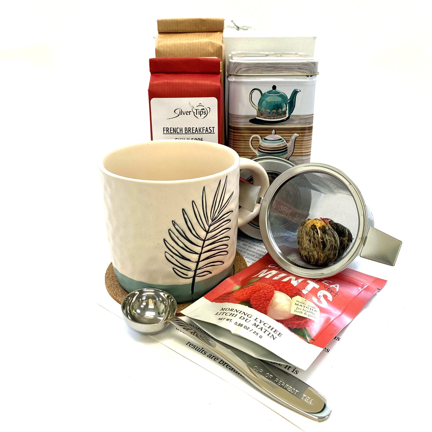 Gift box with variety of teas, canister, infuser, measuring scoop, tea mug, tea mints